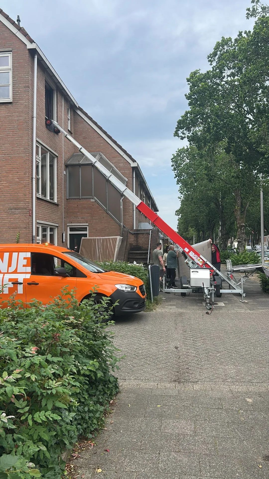 Trailer lift being set up at residential building